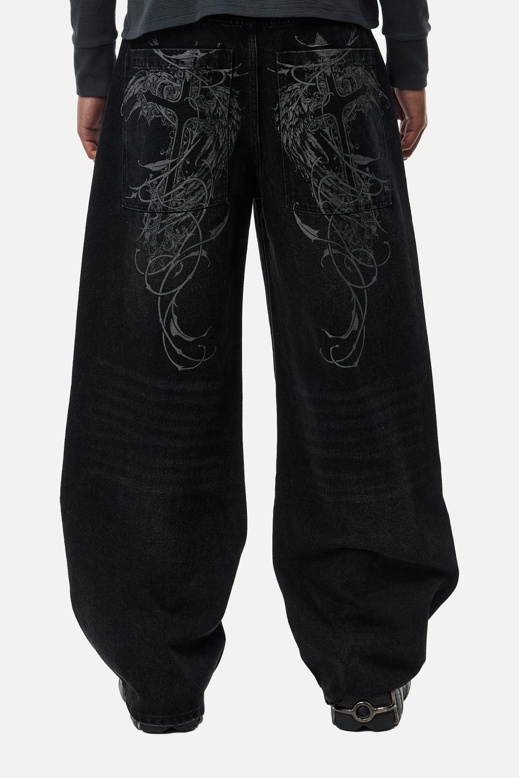 Men's black wide-leg jeans with graphic back pockets and gathered hems