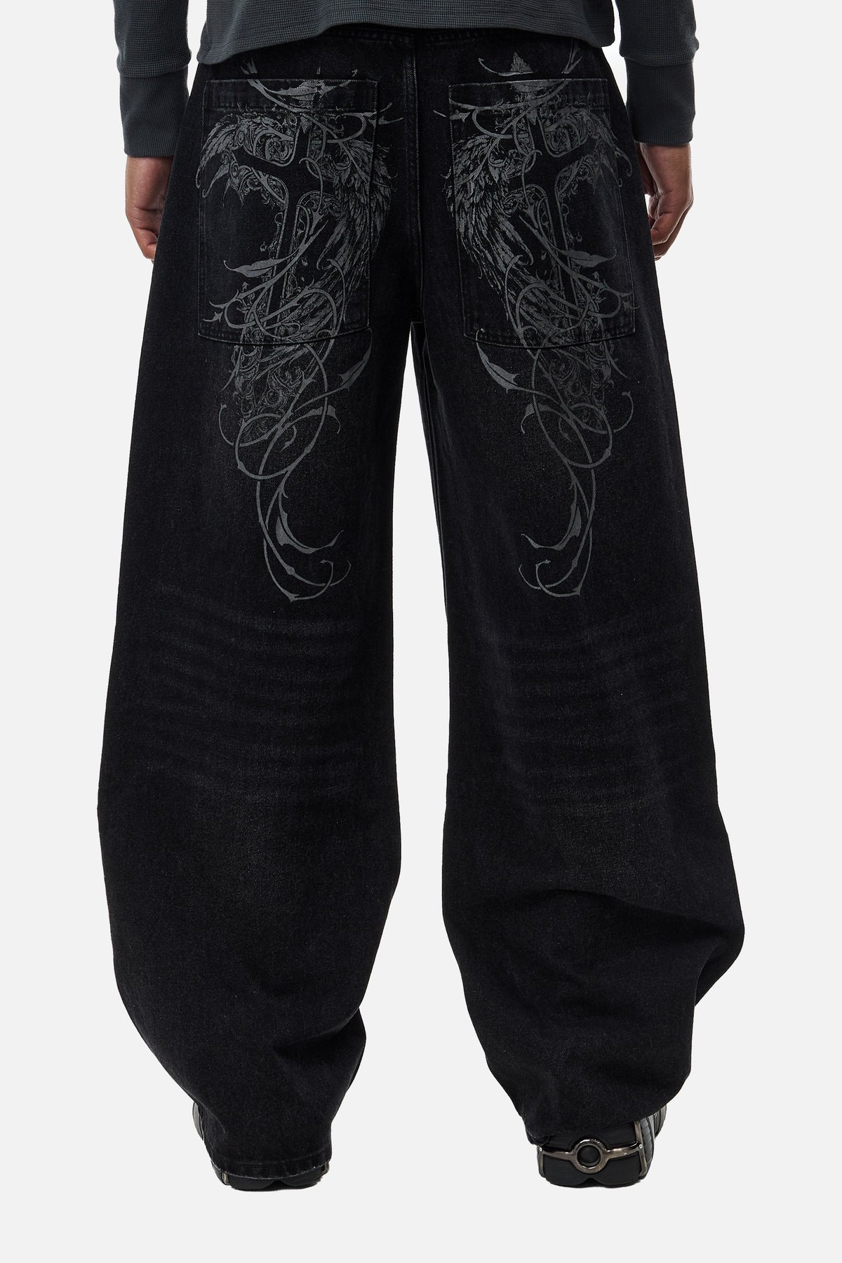 Men's black wide-leg jeans with graphic back pockets and gathered hems
