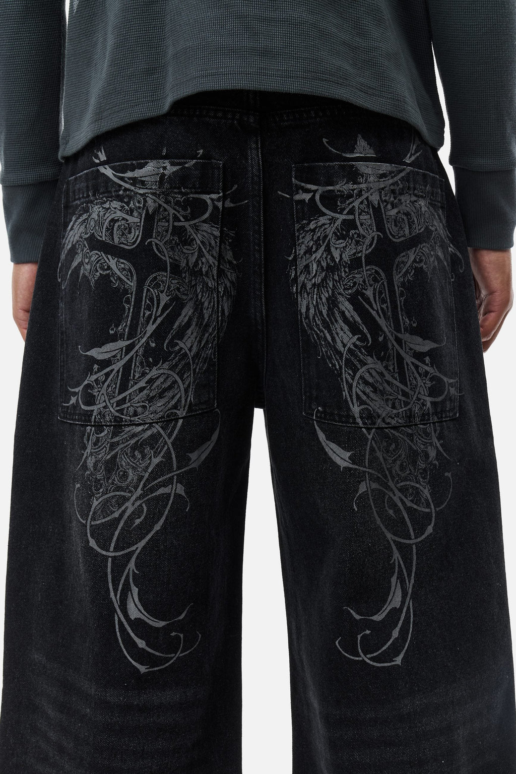 Men's black wide-leg jeans with graphic back pockets and gathered hems