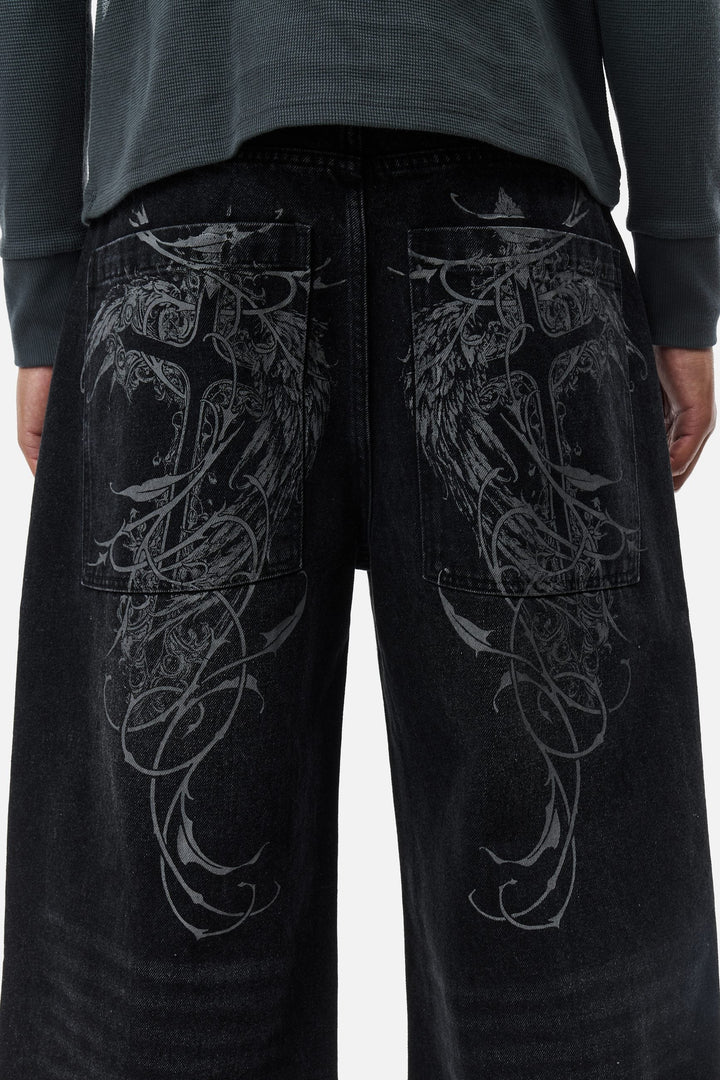 Men's black wide-leg jeans with graphic back pockets and gathered hems
