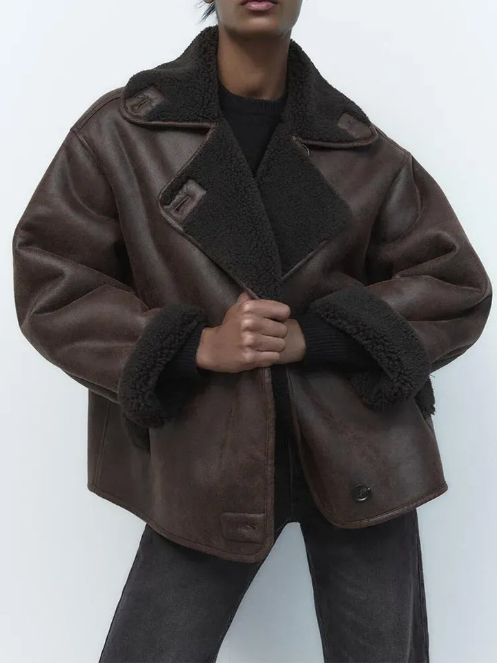 Women's brown oversized aviator jacket with wide dark collar and textured cuffs