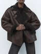 Women's brown oversized aviator jacket with wide dark collar and textured cuffs