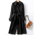 Women's long belted double-breasted trench coat with notched lapels and buckle cuffs