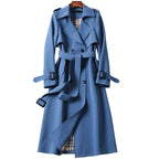 Women's long belted double-breasted trench coat with notched lapels and buckle cuffs