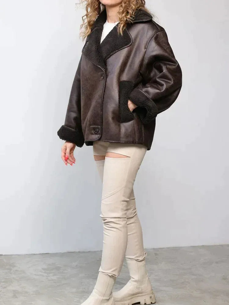 Women's brown oversized aviator jacket with wide dark collar and textured cuffs