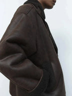 Women's brown oversized aviator jacket with wide dark collar and textured cuffs