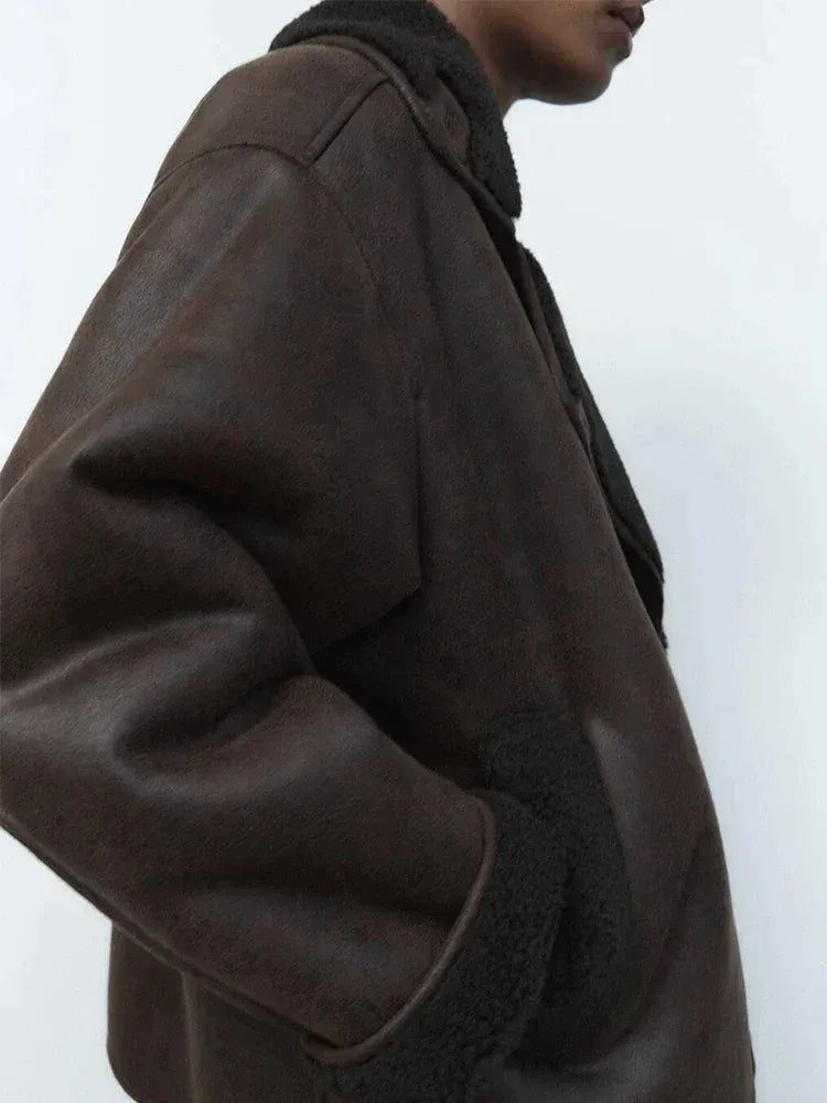 Women's brown oversized aviator jacket with wide dark collar and textured cuffs