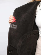 Women's brown oversized aviator jacket with wide dark collar and textured cuffs