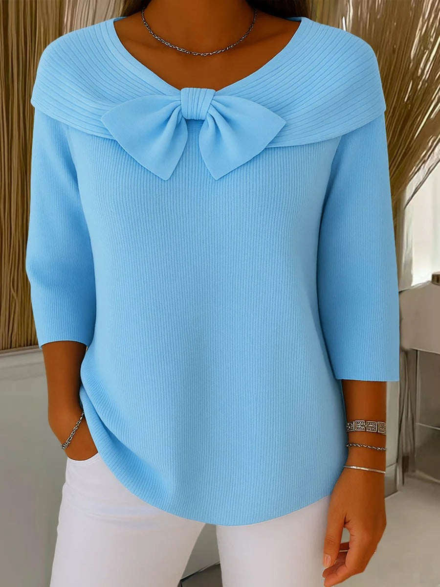 Women's ribbed sweater with a large bow and three-quarter sleeves