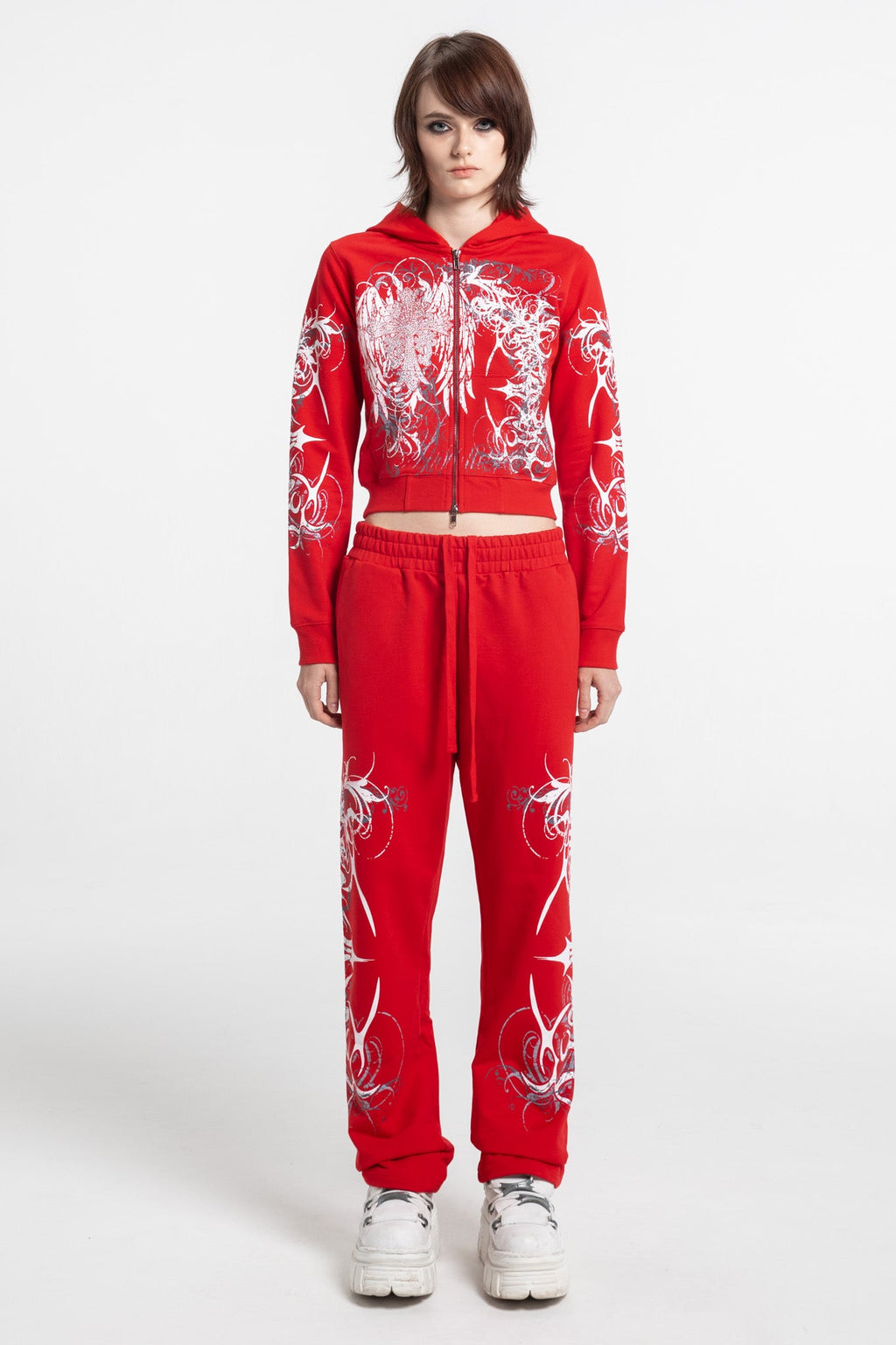 Women's red cropped hoodie with white and grey graphic print, hood and zip front