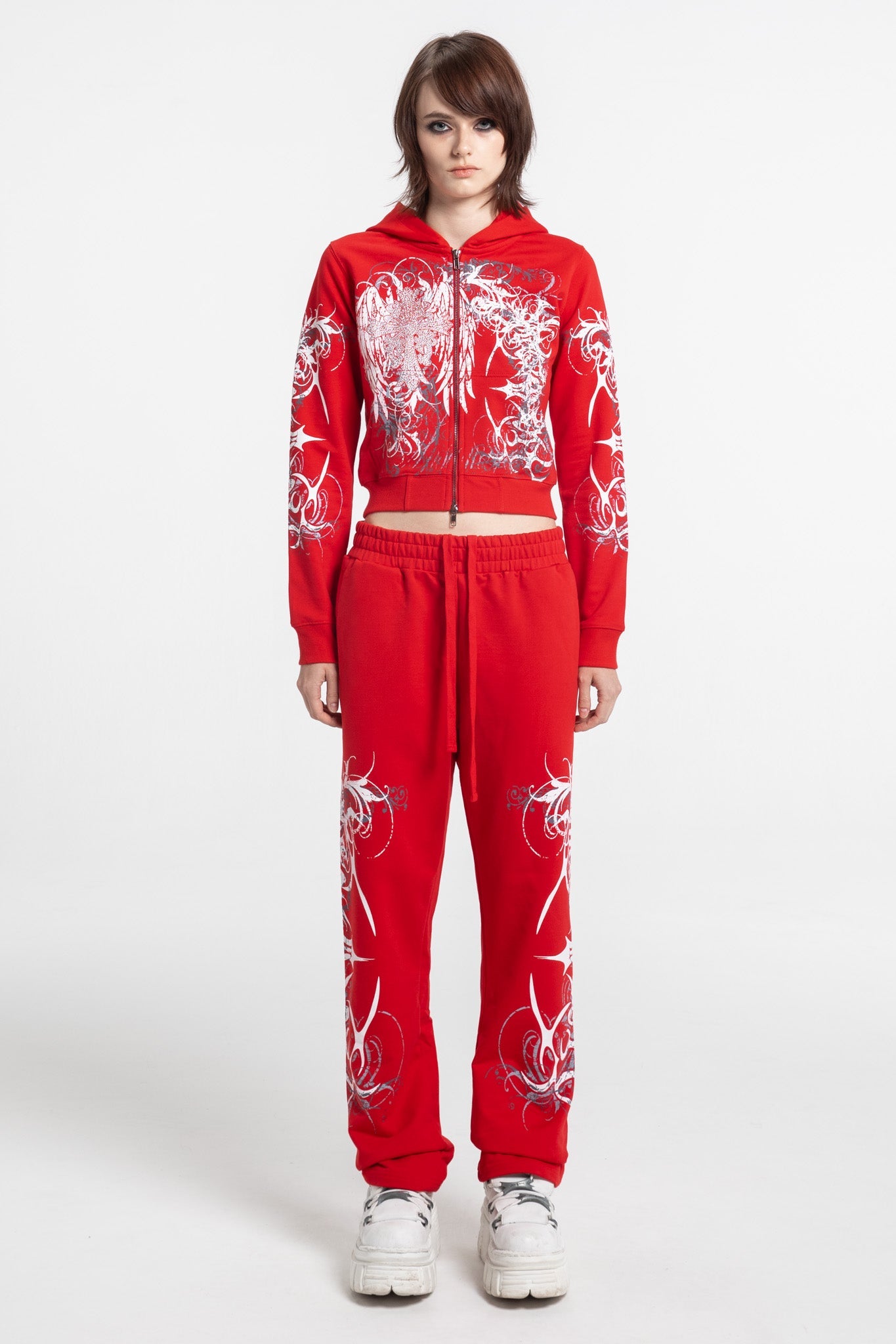 Women's red cropped hoodie with white and grey graphic print, hood and zip front