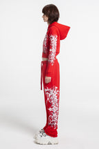 Women's red cropped hoodie with white and grey graphic print, hood and zip front