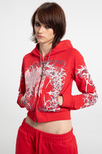 Women's red cropped hoodie with white and grey graphic print, hood and zip front