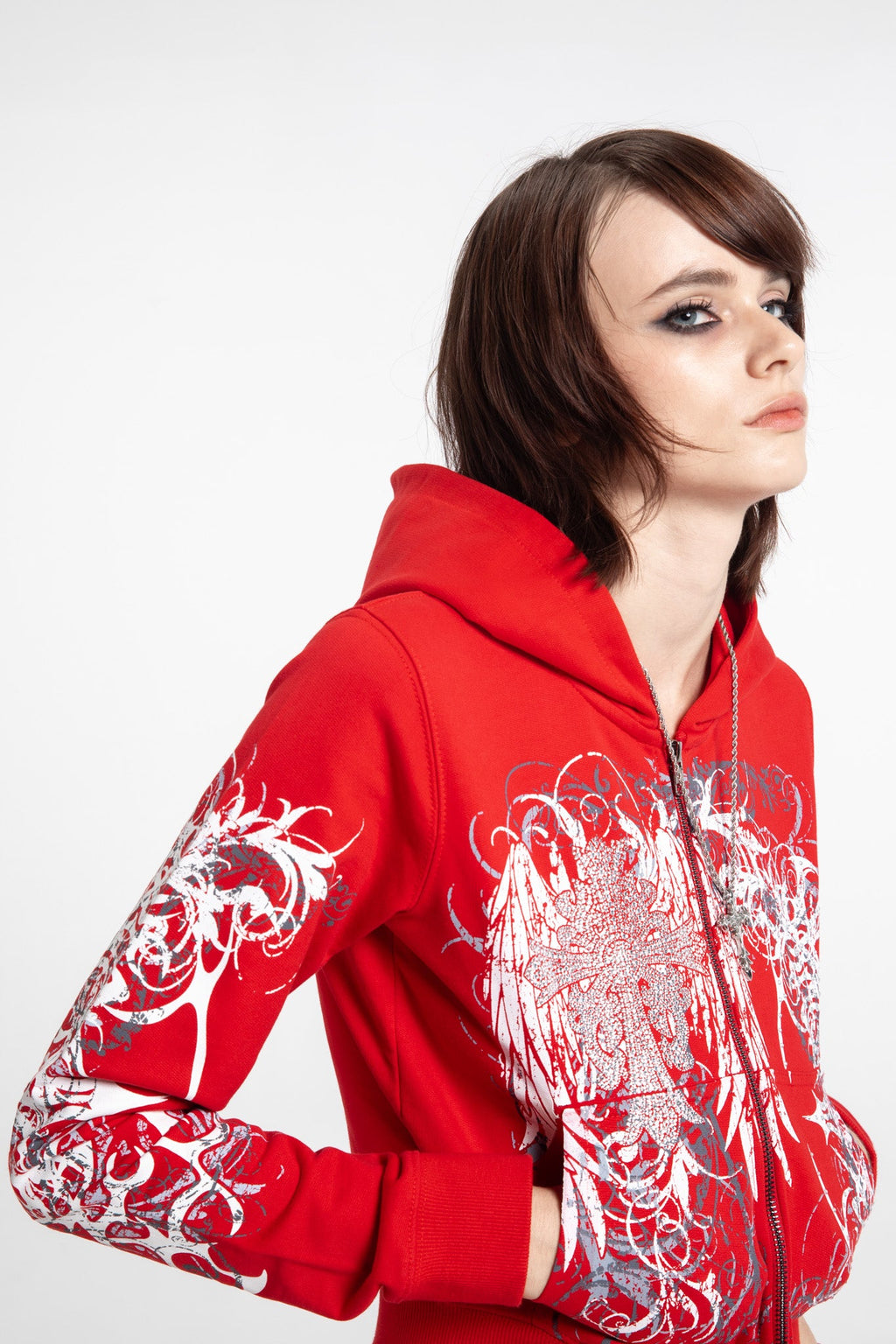 Women's red cropped hoodie with white and grey graphic print, hood and zip front