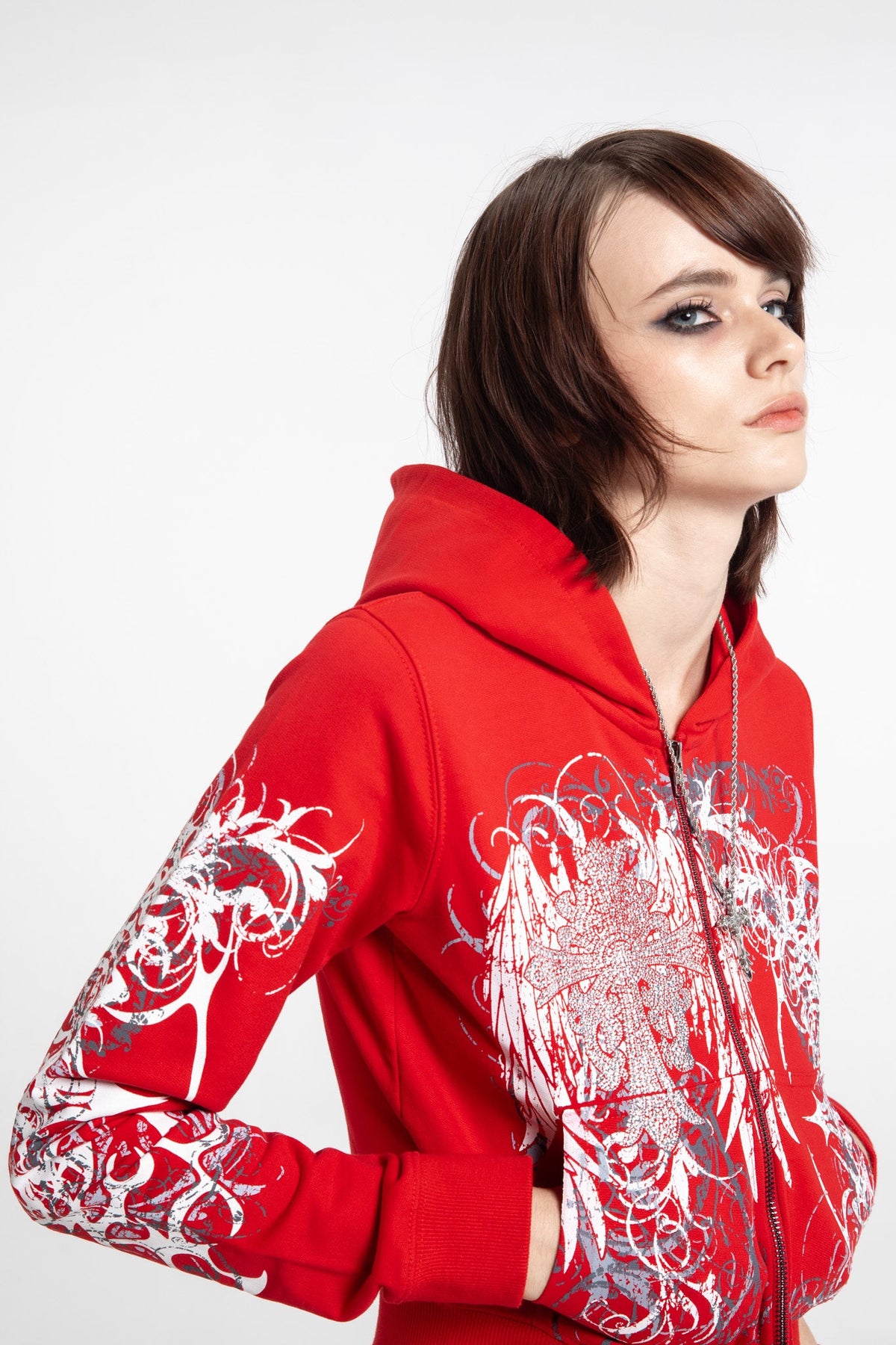 Women's red cropped hoodie with white and grey graphic print, hood and zip front