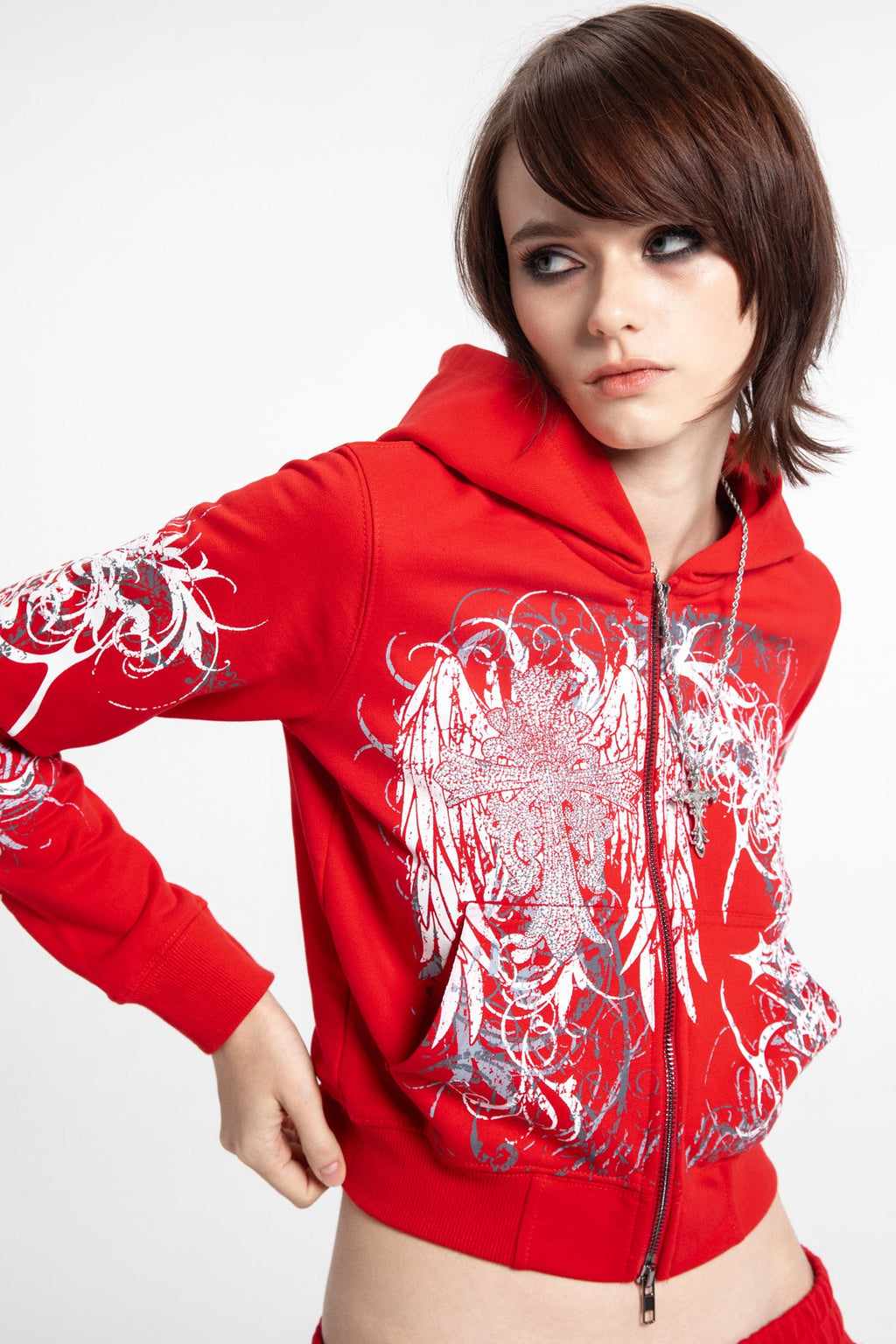 Women's red cropped hoodie with white and grey graphic print, hood and zip front
