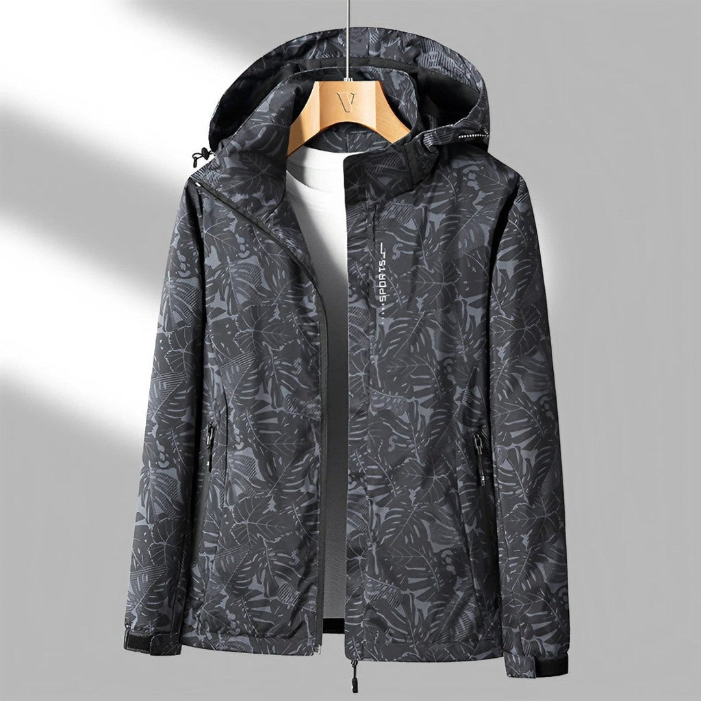 Women's hooded leaf pattern rain jacket with long sleeves and zipped pockets