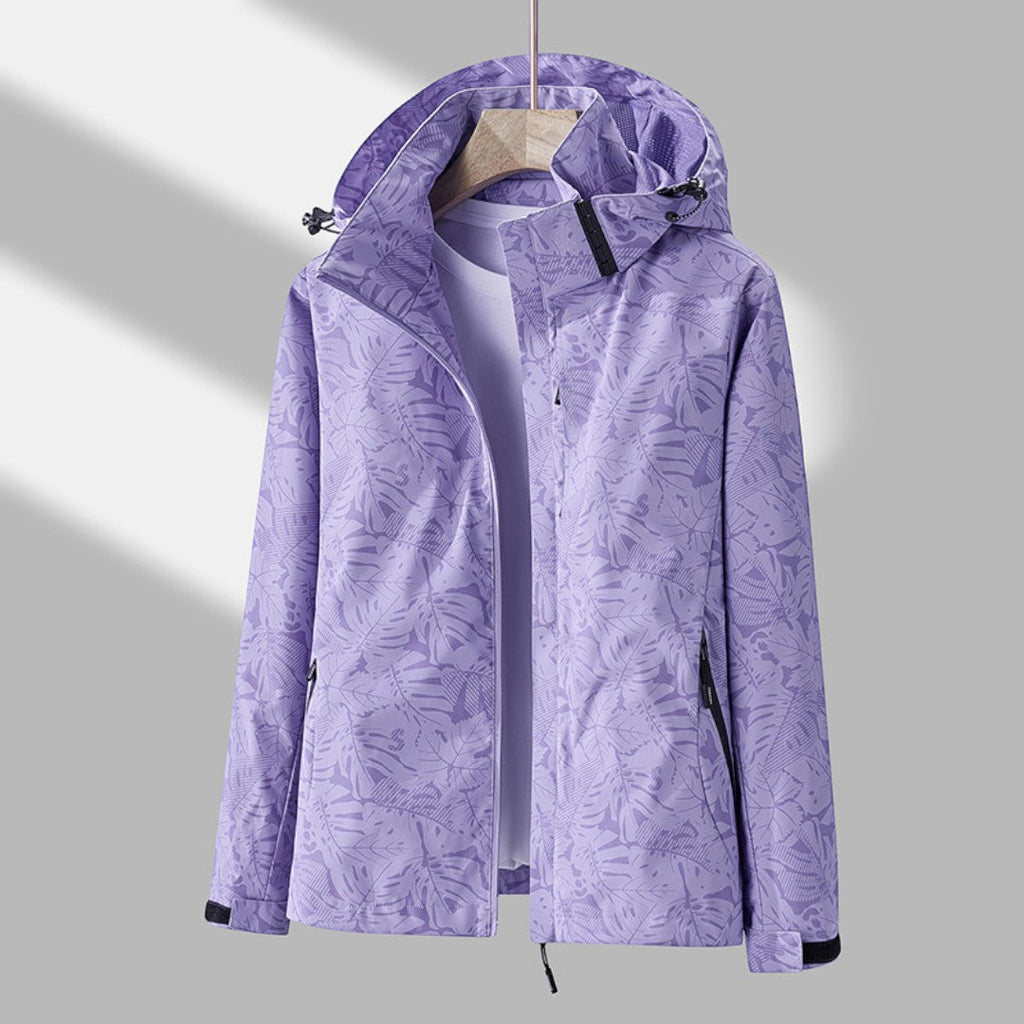 Women's hooded leaf pattern rain jacket with long sleeves and zipped pockets