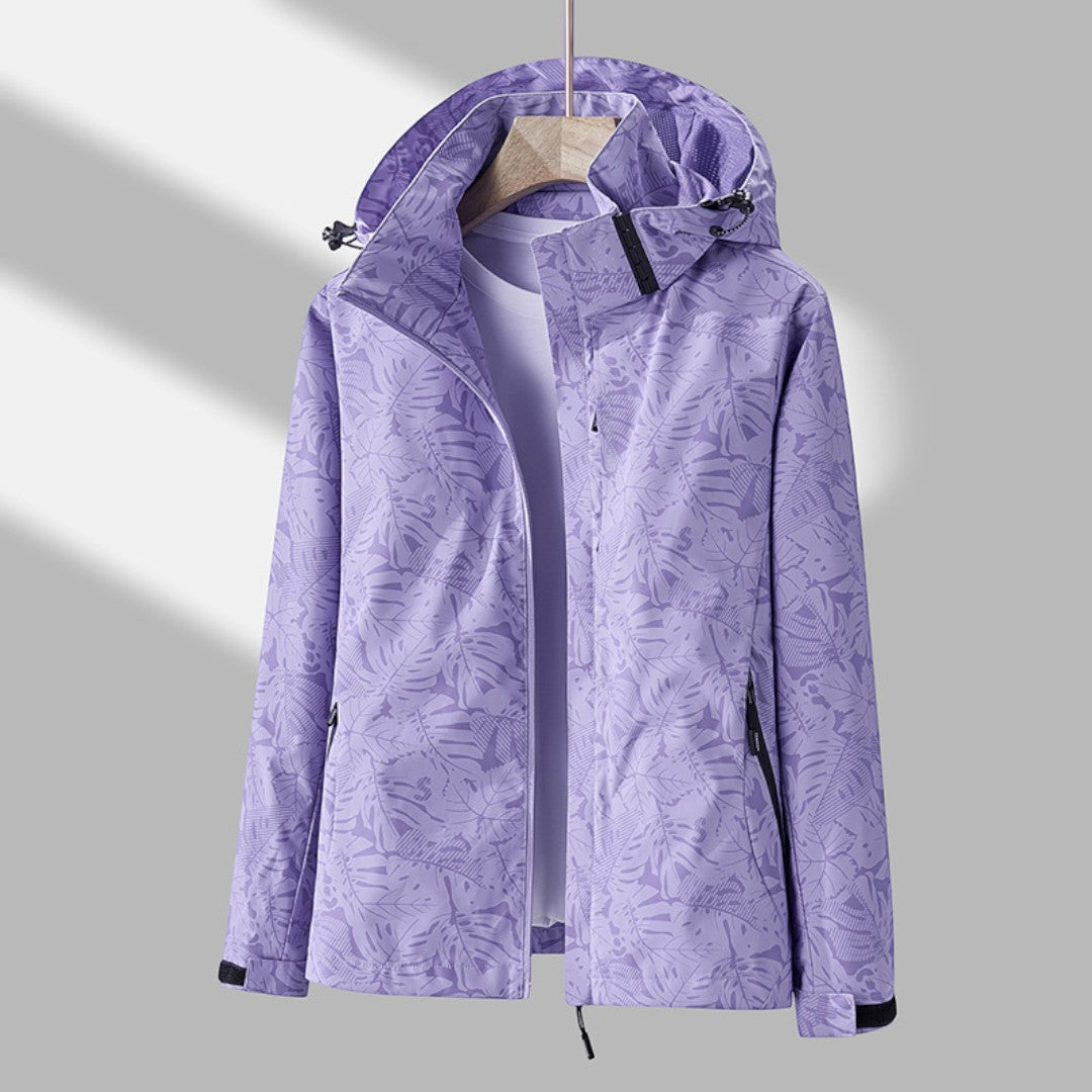 Women's hooded leaf pattern rain jacket with long sleeves and zipped pockets