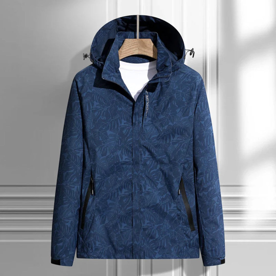 Women's hooded leaf pattern rain jacket with long sleeves and zipped pockets
