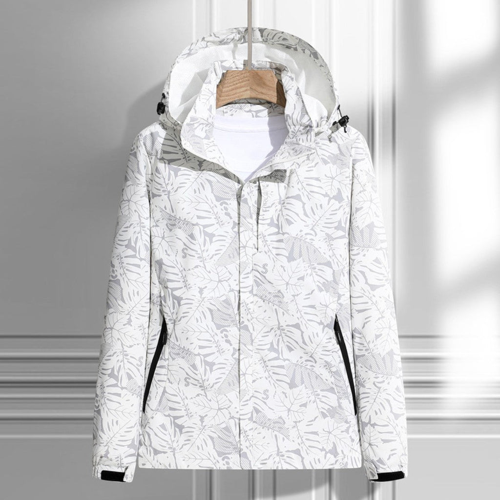Women's hooded leaf pattern rain jacket with long sleeves and zipped pockets