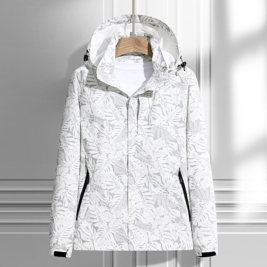 Women's hooded leaf pattern rain jacket with long sleeves and zipped pockets