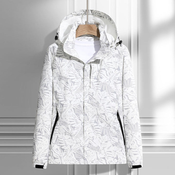 Women's hooded leaf pattern rain jacket with long sleeves and zipped pockets