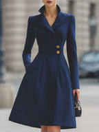 Women's navy tailored coat dress with peak lapels and gold-tone buttons