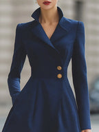 Women's navy tailored coat dress with peak lapels and gold-tone buttons