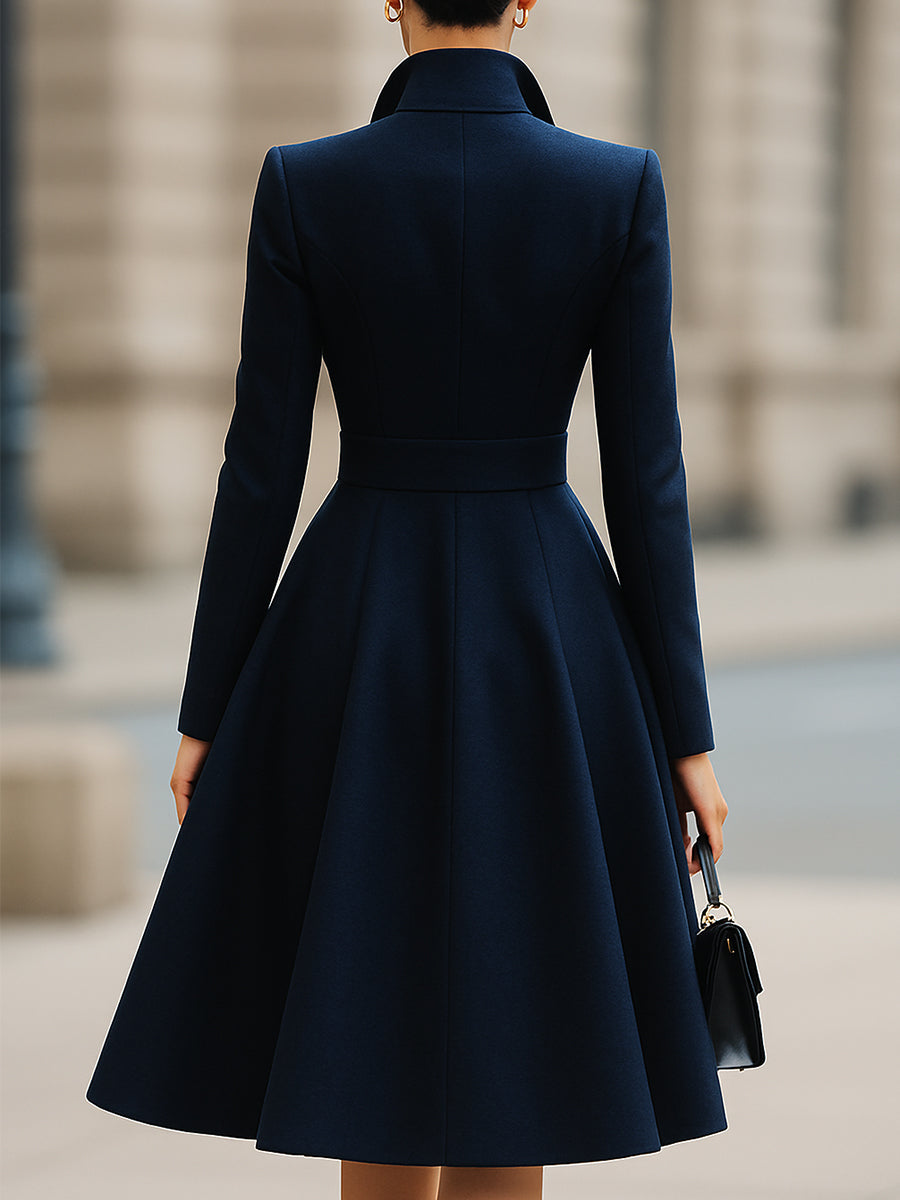 Women's navy tailored coat dress with peak lapels and gold-tone buttons