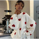 Women's knitted jumper with scattered contrasting motifs