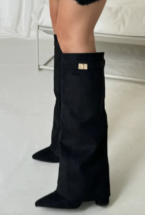 Women's black pointed toe knee-high boots with buckle detail