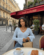 Women's pale blue cropped openwork cardigan with V-neck, buttons and flared cuffs