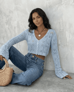 Women's pale blue cropped openwork cardigan with V-neck, buttons and flared cuffs