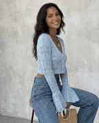 Women's pale blue cropped openwork cardigan with V-neck, buttons and flared cuffs