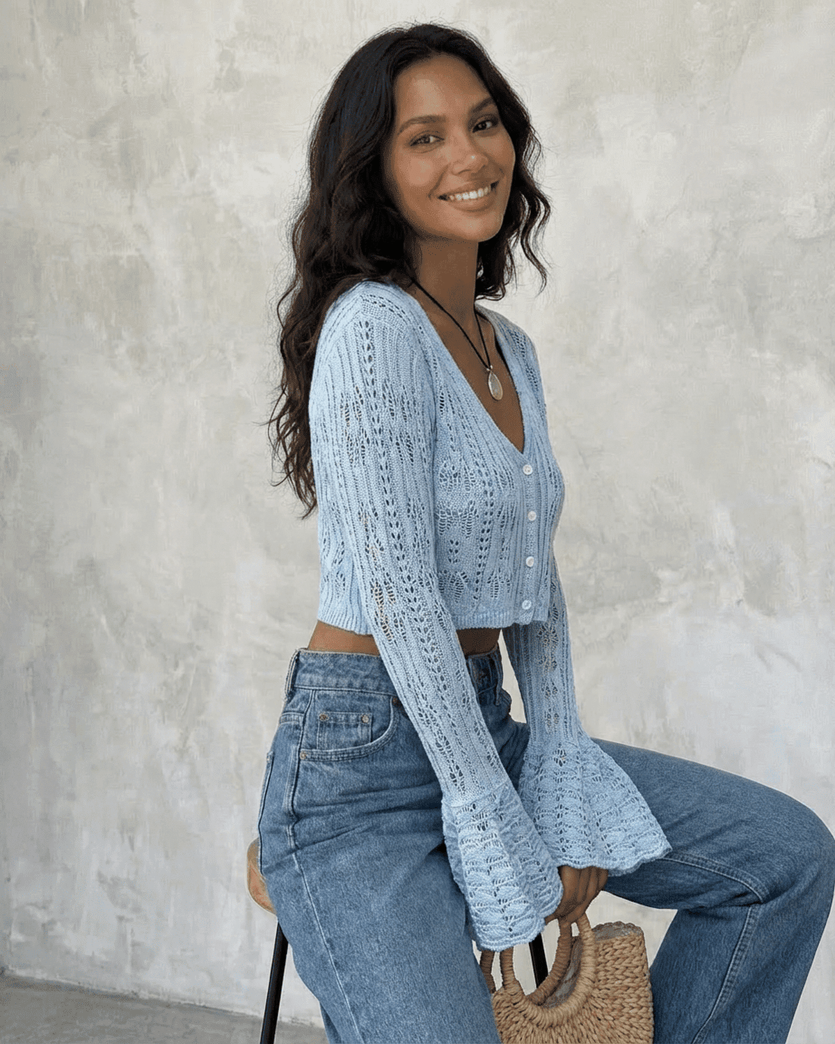 Women's pale blue cropped openwork cardigan with V-neck, buttons and flared cuffs