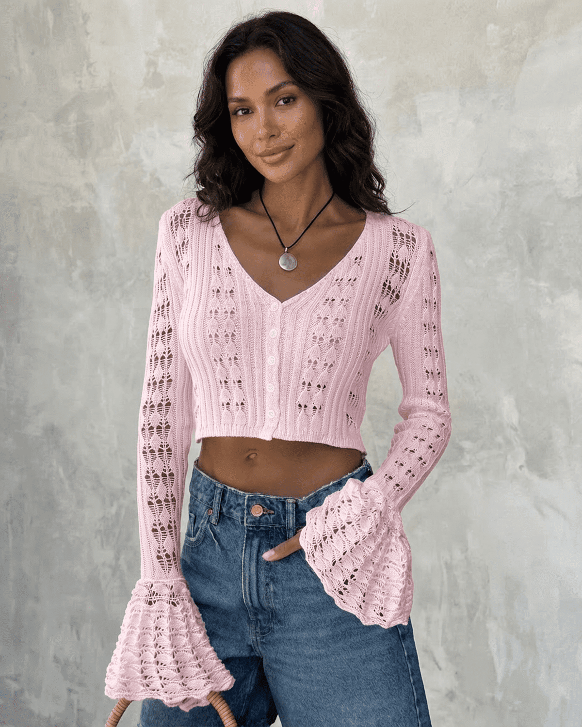 Women's pink cropped openwork cardigan with V-neckline and flared cuffs