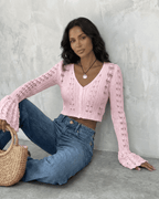 Women's pink cropped openwork cardigan with V-neckline and flared cuffs