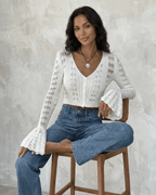 Women's white openwork cropped cardigan with V-neck and flared sleeves