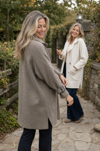 Women's longline double-breasted coat with knitted sleeves and buckle cuffs