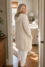 Women's longline hooded cable knit cardigan with long sleeves and front pockets