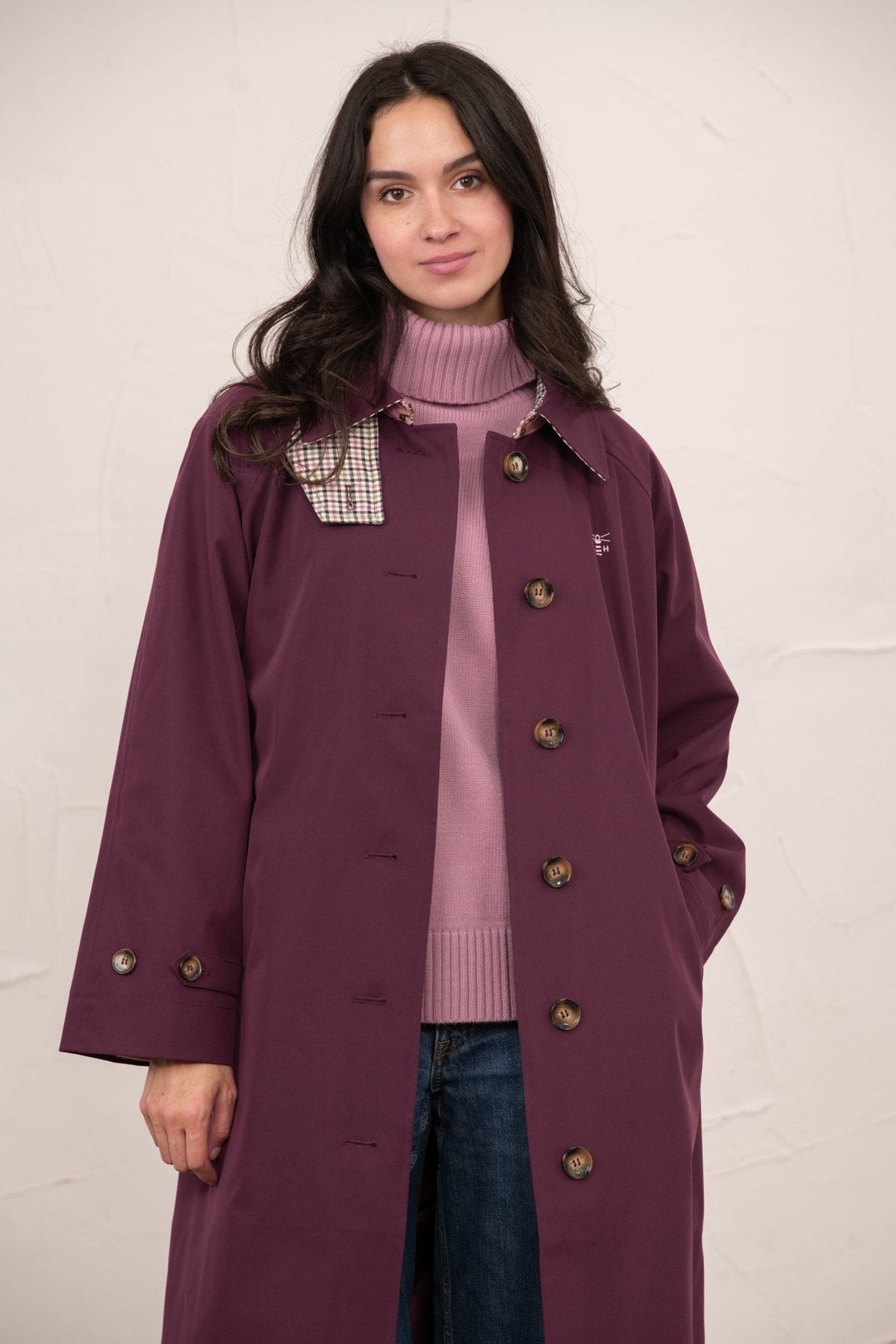 Women's longline waterproof trench coat with button front and checked collar trim