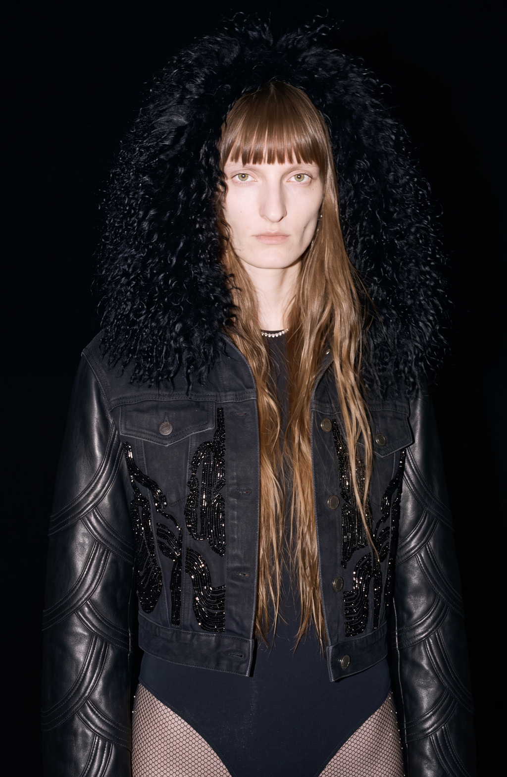 Black cropped jacket with textured collar, long sleeves and front embellishment