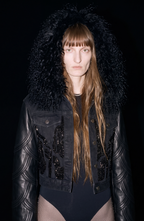 Black cropped jacket with textured collar, long sleeves and front embellishment