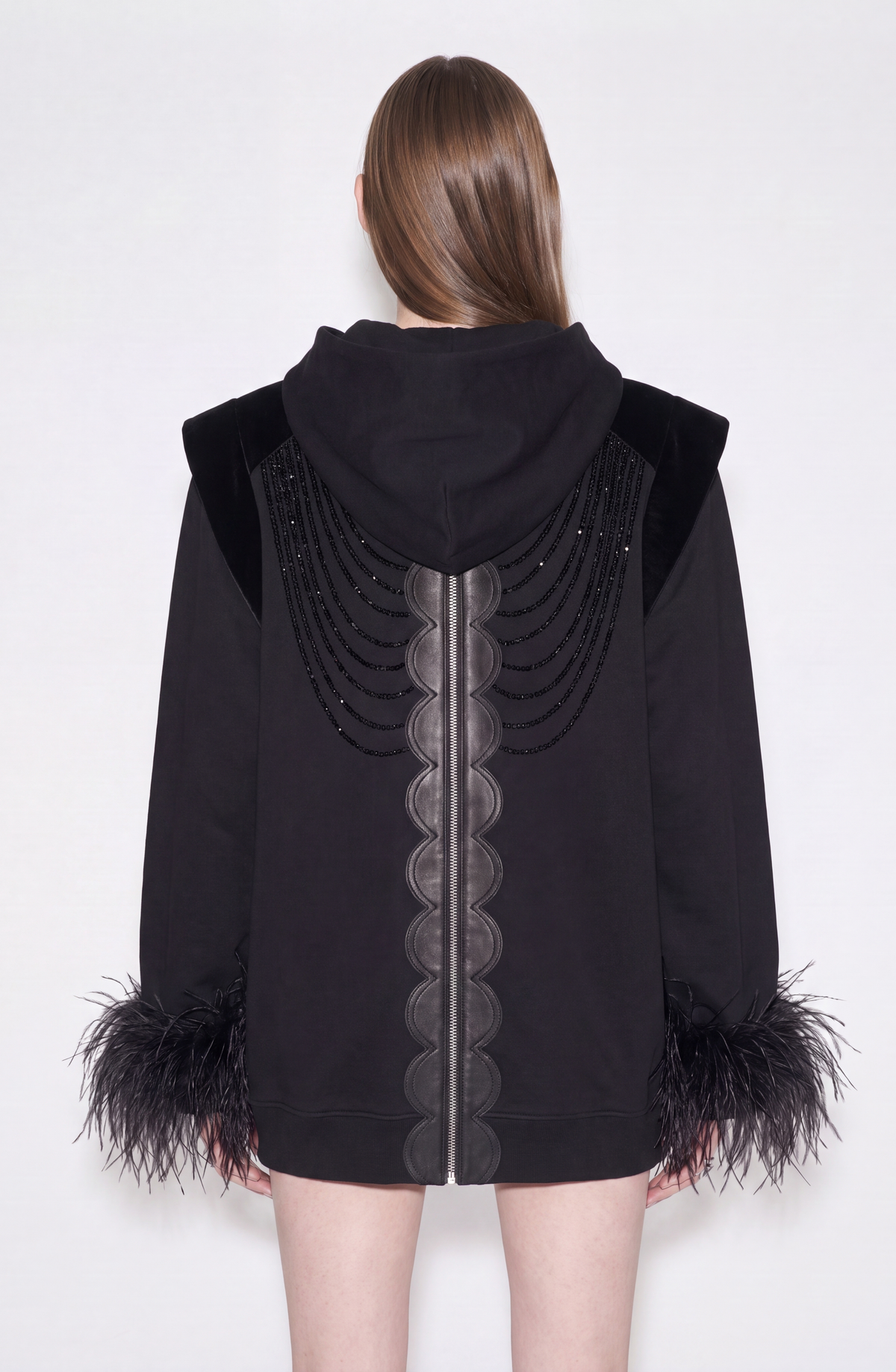 Women's black zip hoodie with embellished front and feather-trimmed cuffs
