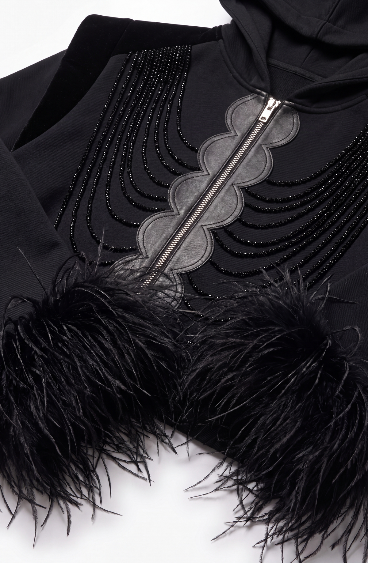 Women's black zip hoodie with embellished front and feather-trimmed cuffs
