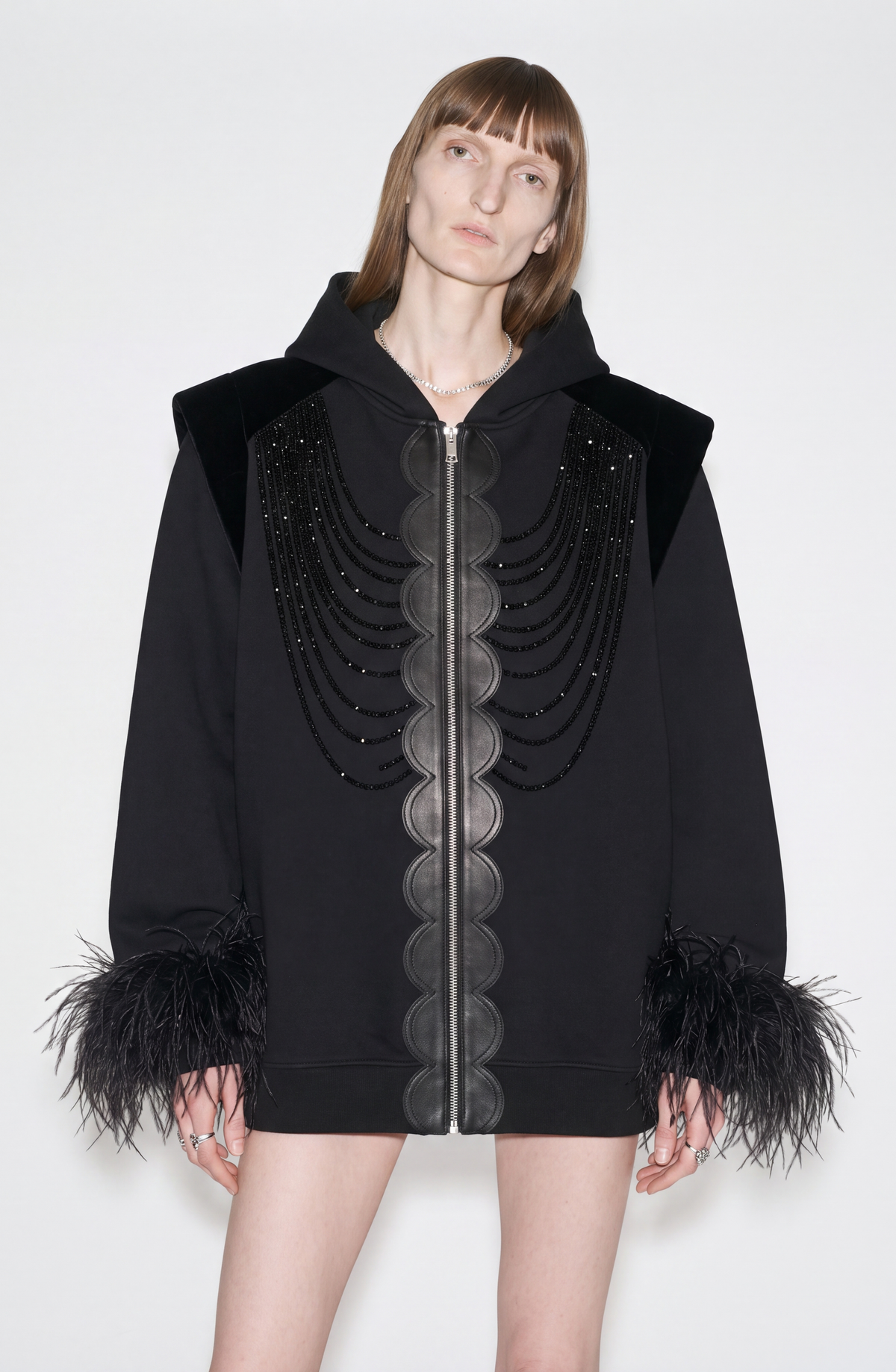 Women's black zip hoodie with embellished front and feather-trimmed cuffs