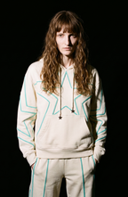 Cream hoodie with turquoise outlined star pattern, drawstring hood and front pouch pocket