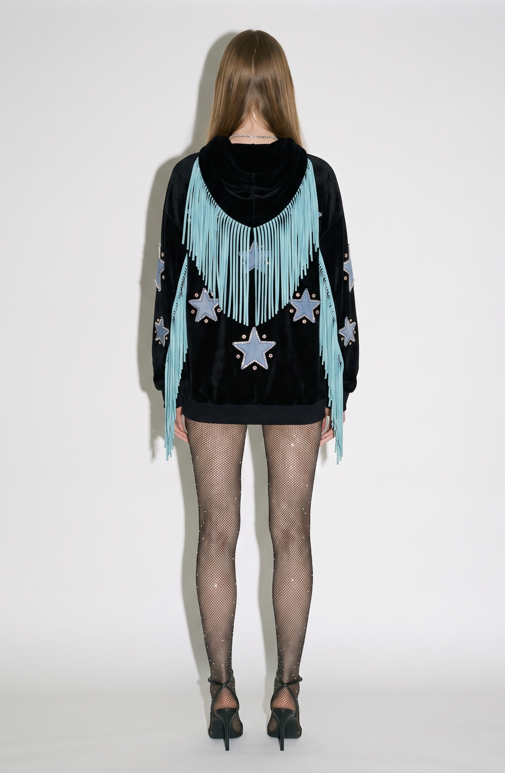 Black velvet hoodie with blue star appliqués and turquoise hood fringe