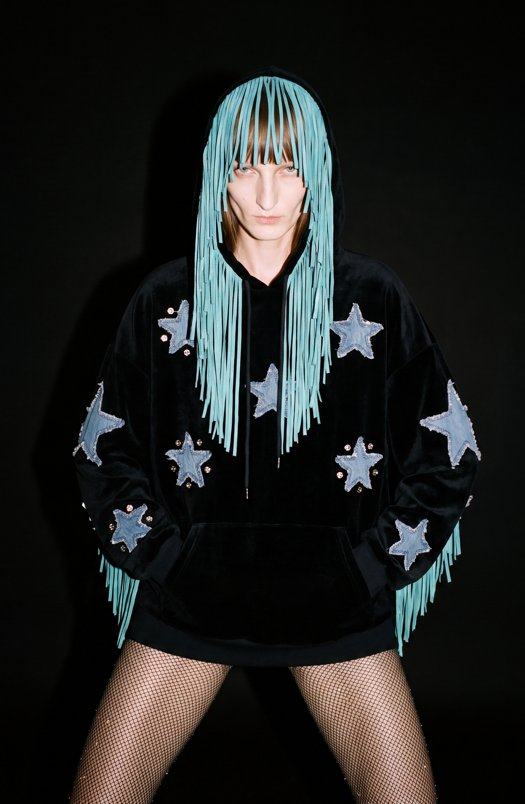Black velvet hoodie with blue star appliqués and turquoise hood fringe